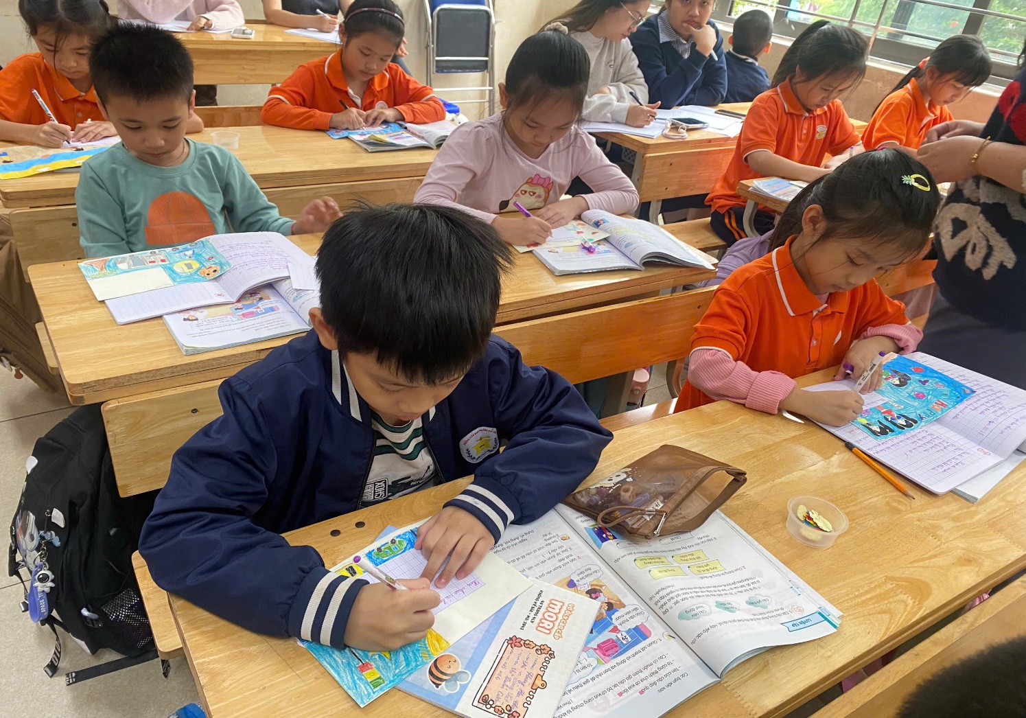 A group of children sitting at desks in a classroom
AI-generated content may be incorrect.