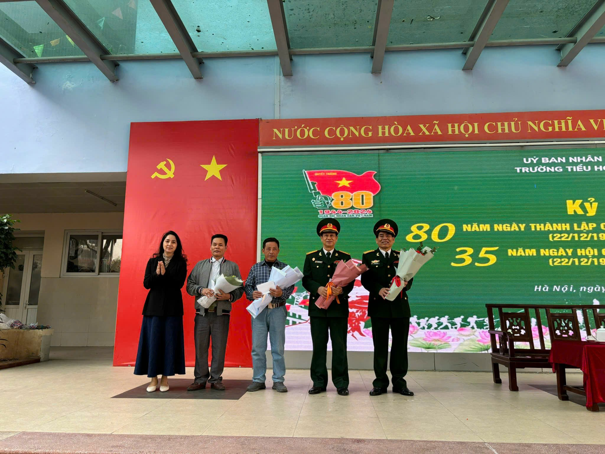 A group of people standing in front of a large sign

AI-generated content may be incorrect.