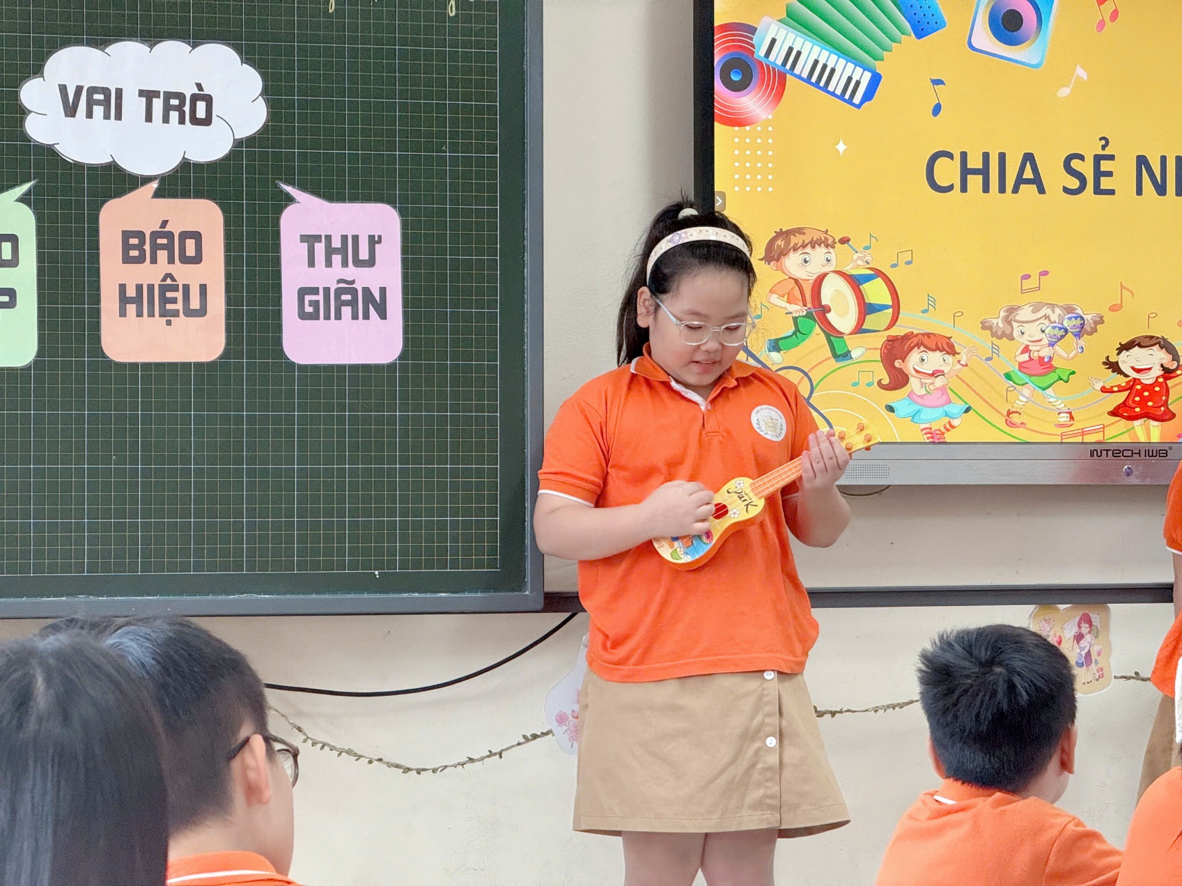 A child playing a toy guitar in front of a group of kids
AI-generated content may be incorrect.