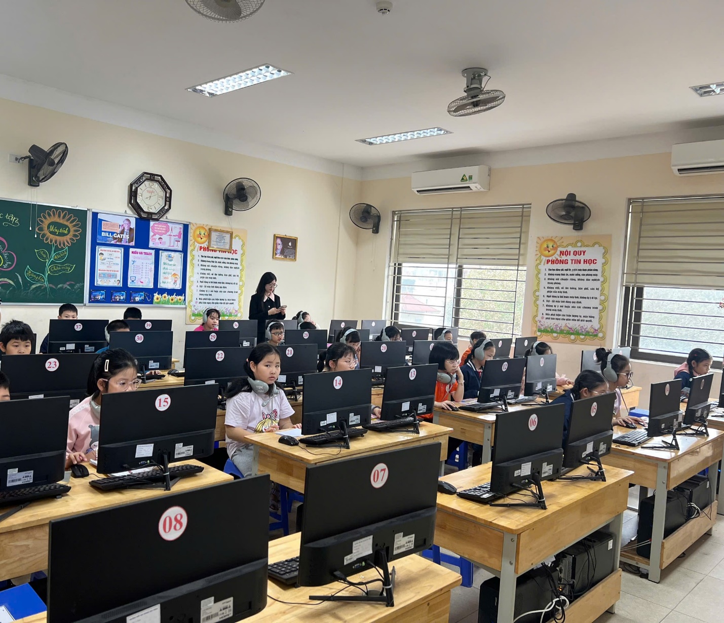A group of children in a classroom with computers

AI-generated content may be incorrect.