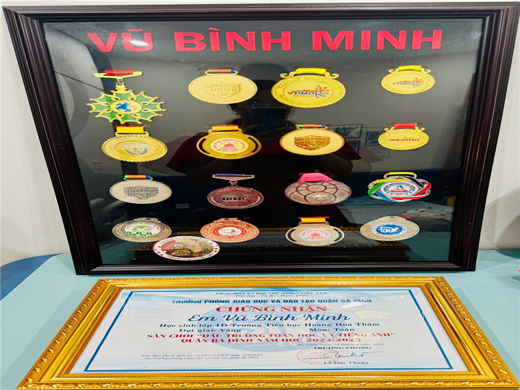 A display case with medals and a picture frame

Description automatically generated