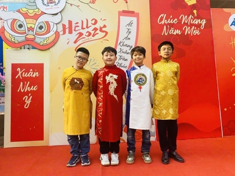 A group of boys in traditional dresses posing for a photo

Description automatically generated