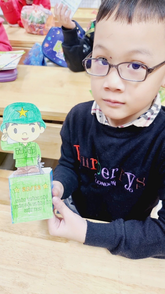 A child holding a paper doll

AI-generated content may be incorrect.