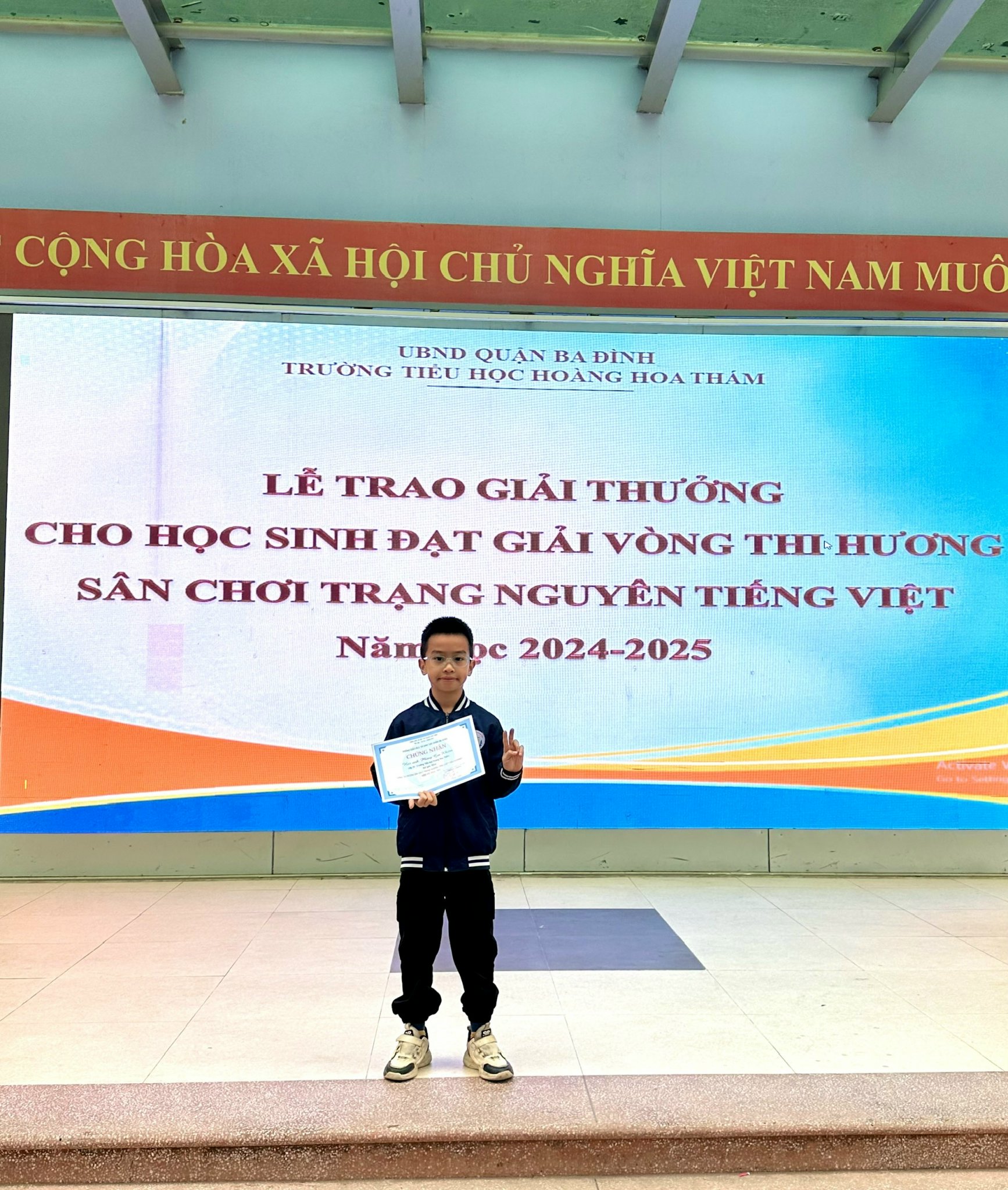 A child holding a certificate AI-generated content may be incorrect.