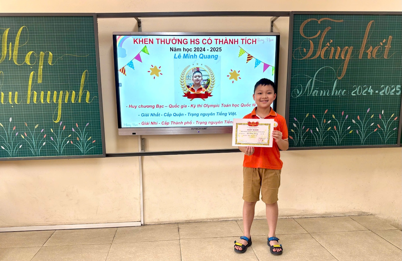 A child holding a certificate in front of a screen  AI-generated content may be incorrect.
