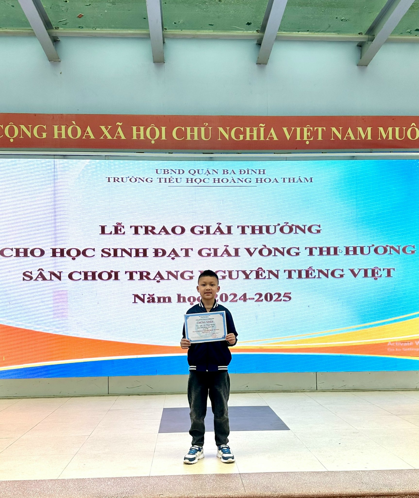 A child holding a certificate  AI-generated content may be incorrect.